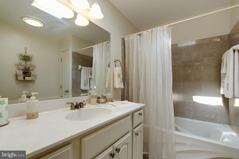 12104 Stirrup Road Reston, VA 20191 - Photo 4 of 27 a bathroom with a sink double vanity and a mirror