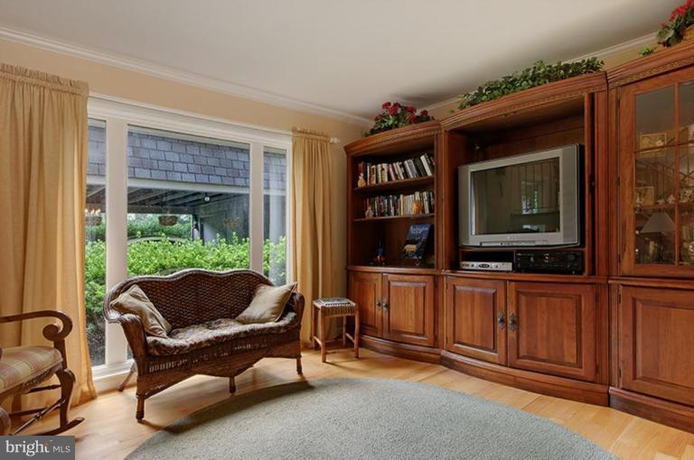 12104 Stirrup Road Reston, VA 20191 - Photo 10 of 27 a living room with furniture a window and a flat screen tv