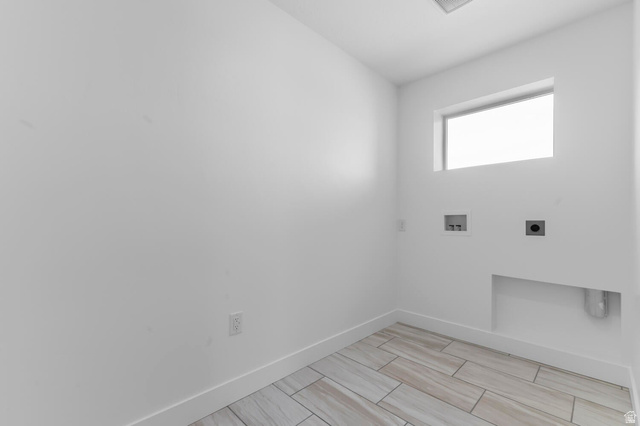 342 North Rhyolite Drive, Unit 88 Hurricane, UT 84737 - Photo 19 of 26 Utility area featuring a transom window, wall-mounted electrical outlet, and tile flooring with a wood-grain pattern
