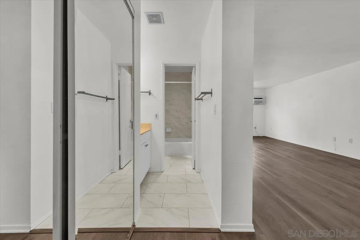6780 Friars Road, Unit 214 San Diego, CA 92108 - Photo 11 of 23 wooden floor with cabinet