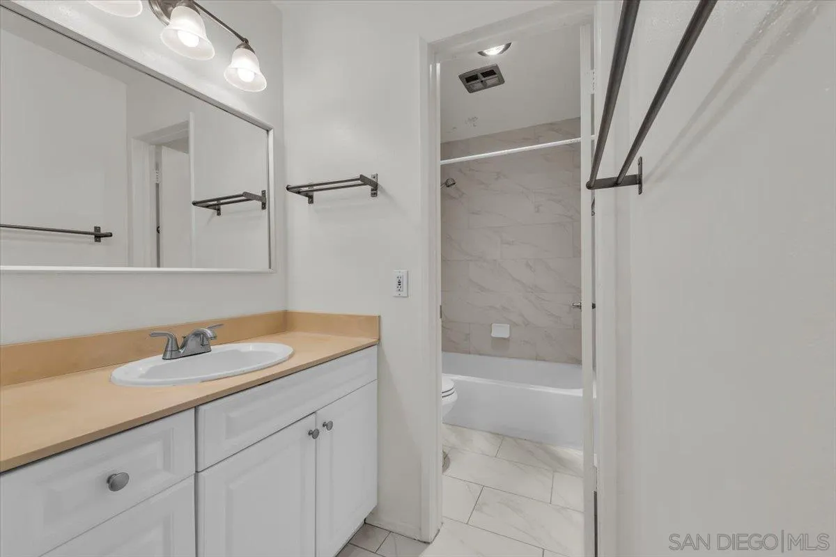 6780 Friars Road, Unit 214 San Diego, CA 92108 - Photo 17 of 23 a bathroom with a granite countertop sink toilet and shower