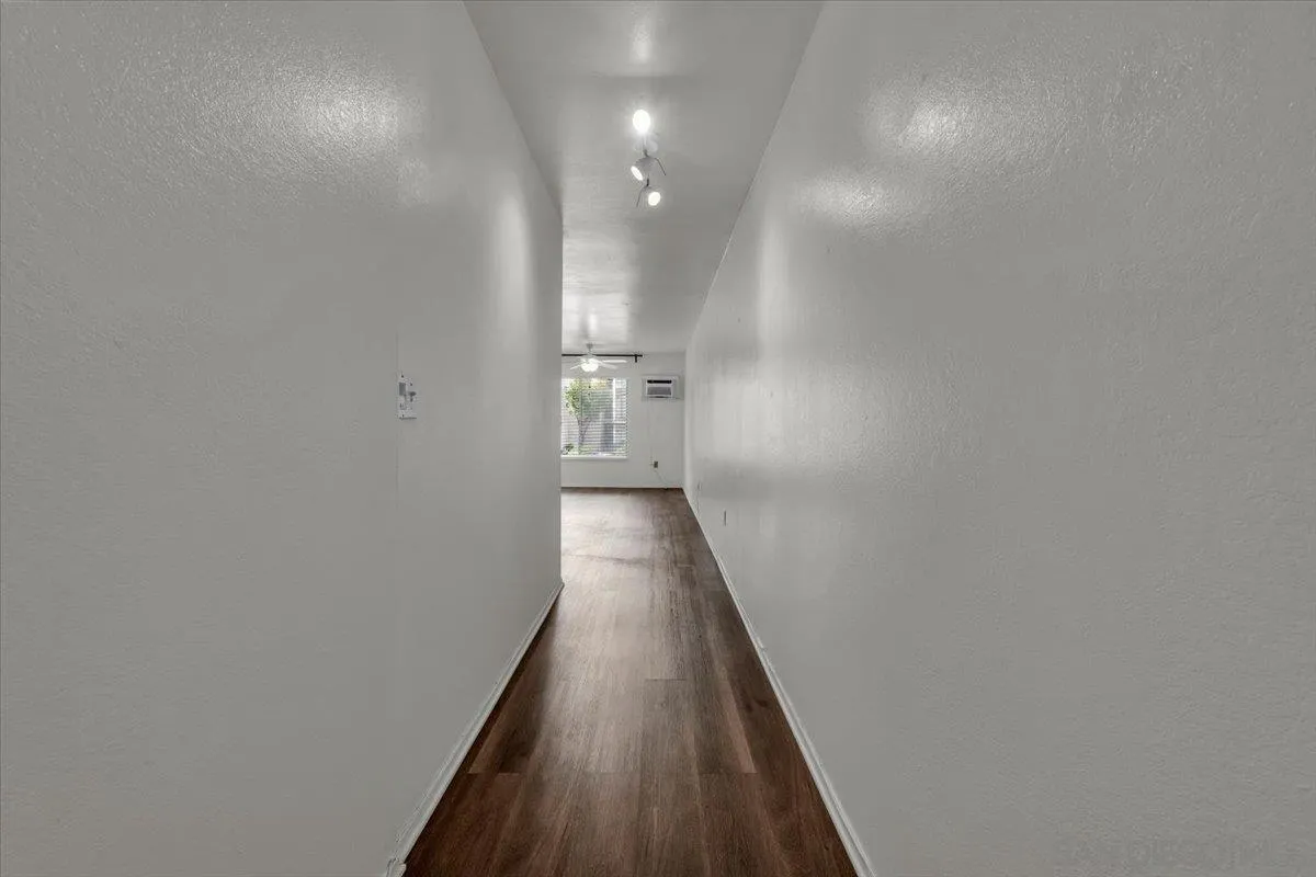 6780 Friars Road, Unit 214 San Diego, CA 92108 - Photo 6 of 23 a view of a hallway with wooden floor