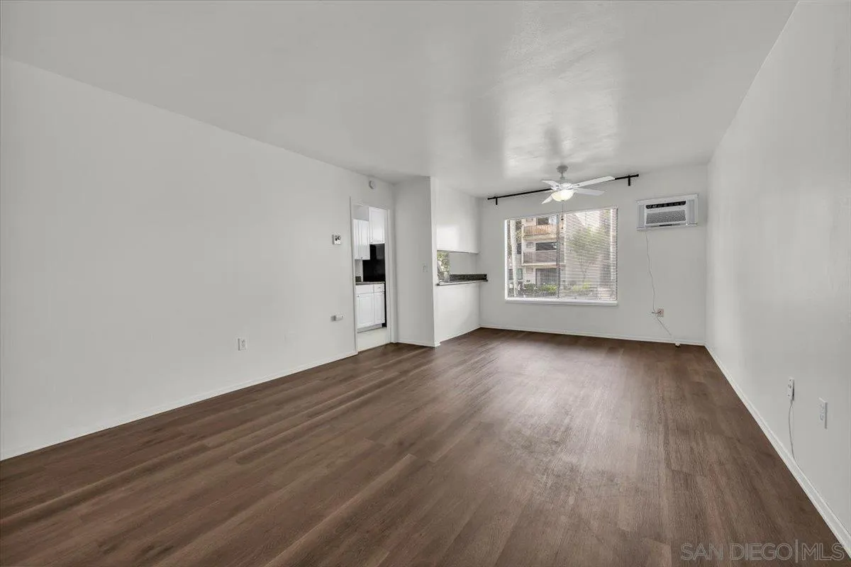 6780 Friars Road, Unit 214 San Diego, CA 92108 - Photo 7 of 23 an empty room with wooden floor and windows