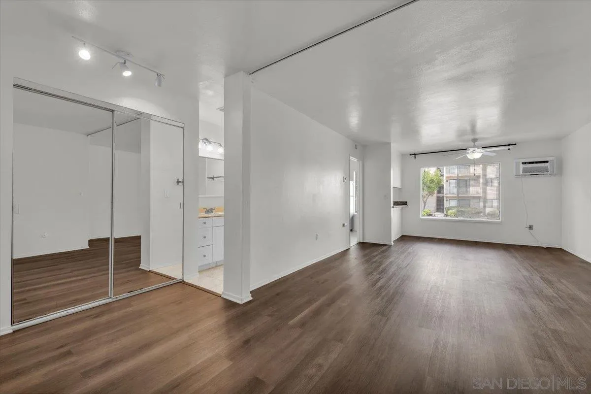 6780 Friars Road, Unit 214 San Diego, CA 92108 - Photo 8 of 23 an empty room with wooden floor and windows