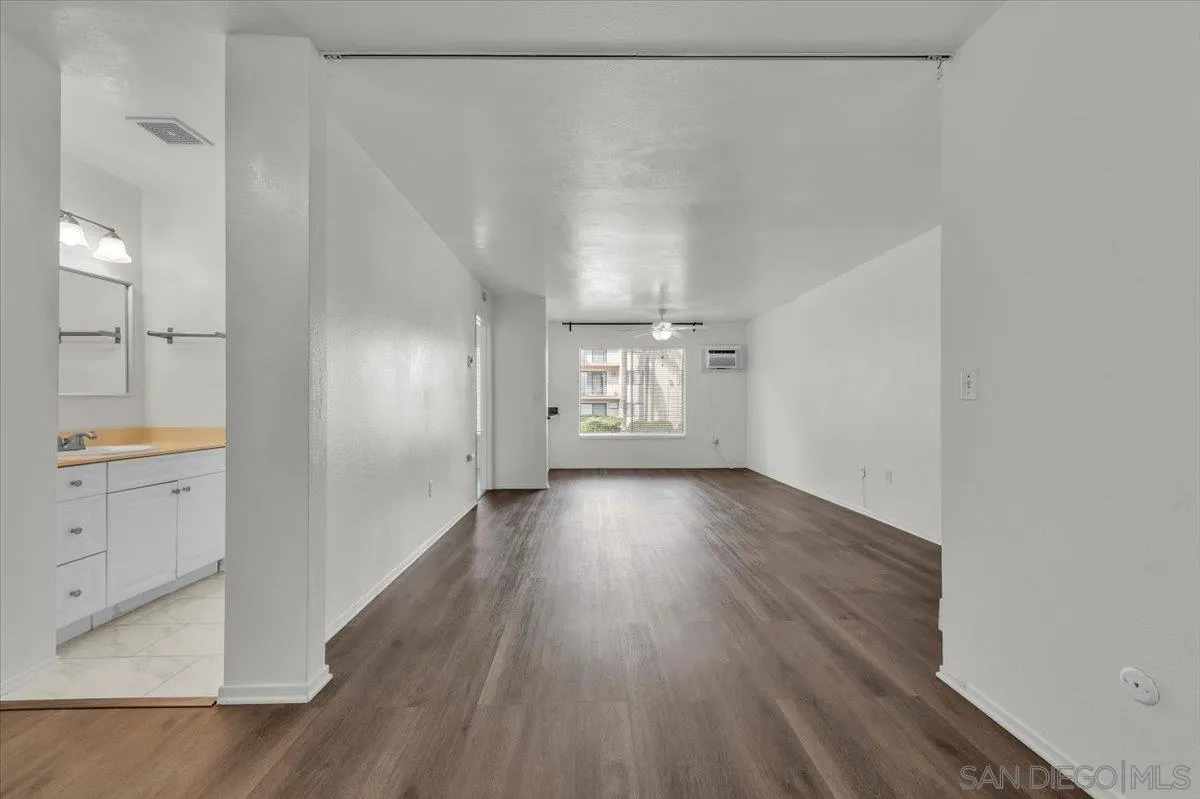6780 Friars Road, Unit 214 San Diego, CA 92108 - Photo 9 of 23 a view of a hallway with wooden floor