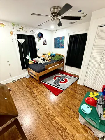 a bedroom with a bed and a flat tv screen