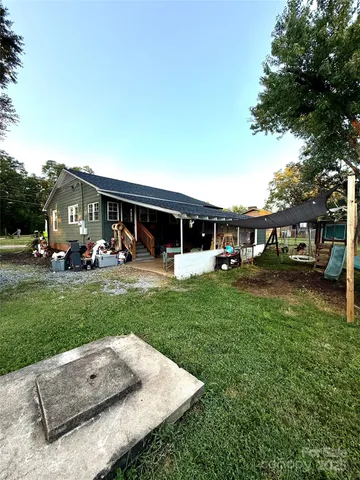 a view of a house with a backyard porch and sitting area