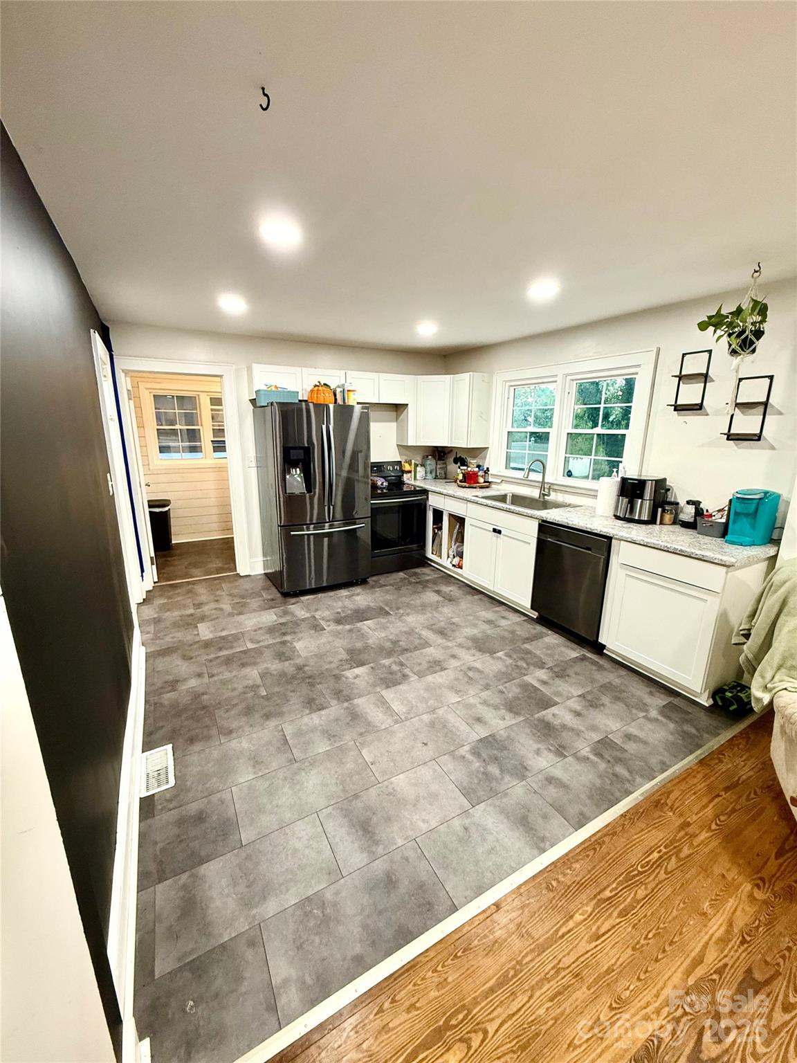 245 Church Street Ellenboro, NC 28040 - Photo 5 of 18 a kitchen with a refrigerator a sink a stove top oven and a dining table