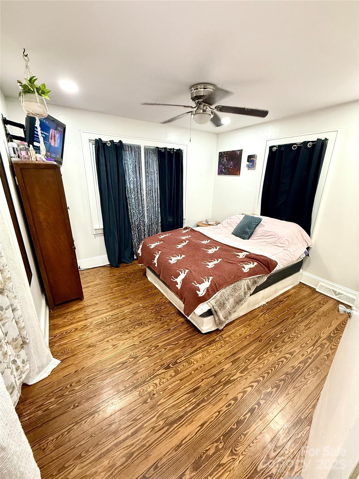 245 Church Street Ellenboro, NC 28040 - Photo 10 of 18 a bedroom with a bed and wooden floor