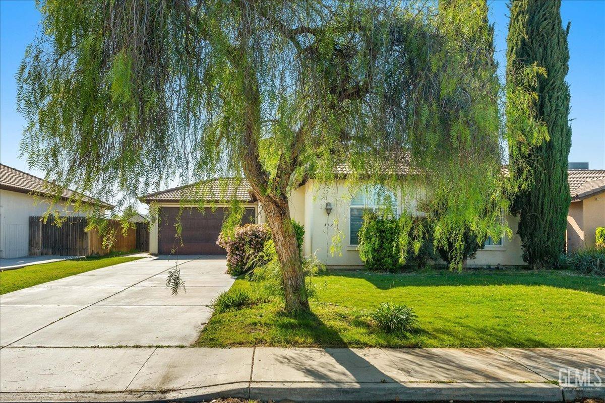 Undisclosed Address Shafter, CA 93263 - Photo 2 of 11 a front view of a house with garden