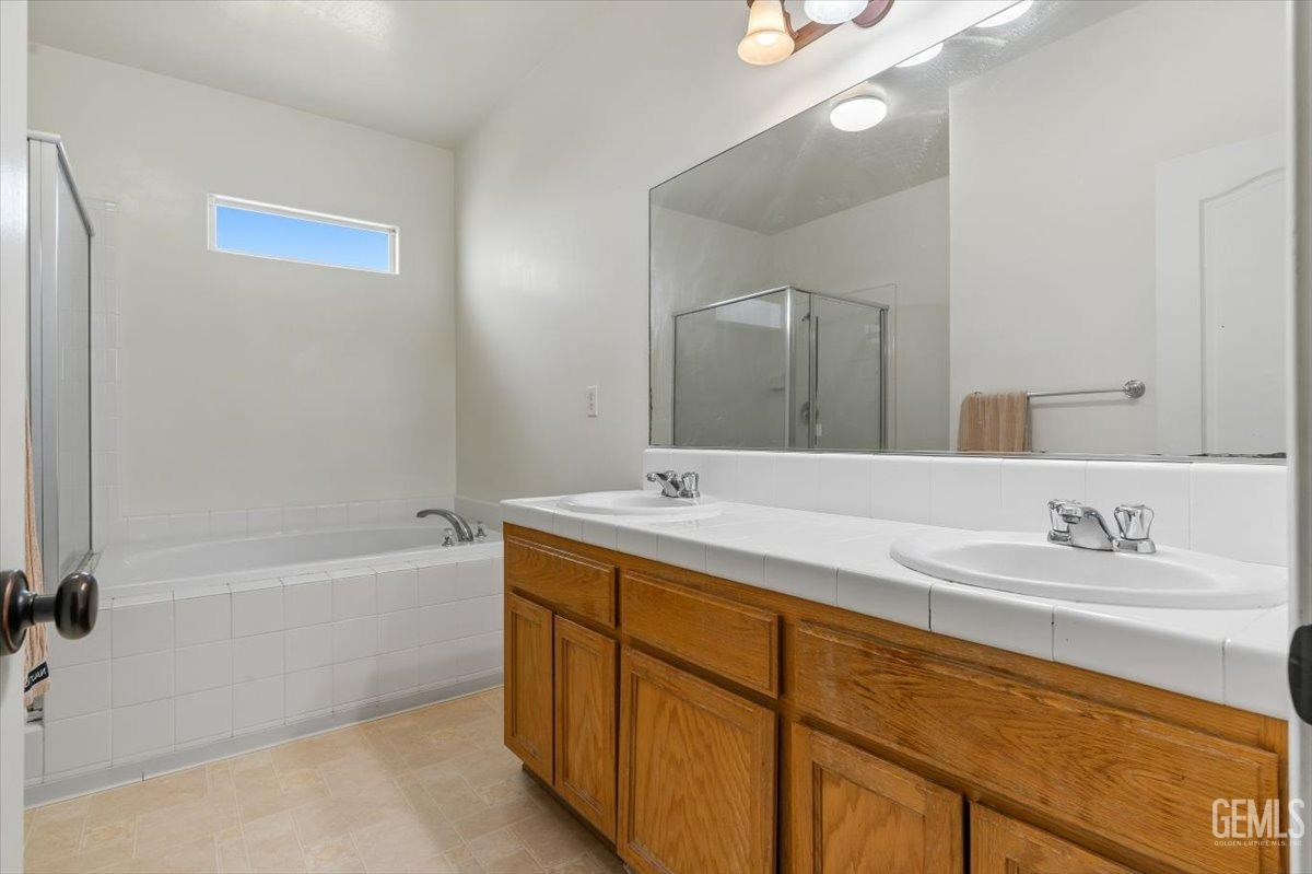 Undisclosed Address Shafter, CA 93263 - Photo 5 of 11 a bathroom with a tub a sink and mirror