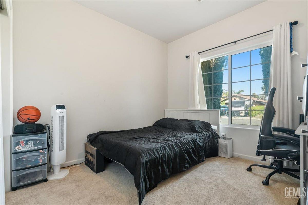 Undisclosed Address Shafter, CA 93263 - Photo 7 of 11 a bedroom with a bed and a window