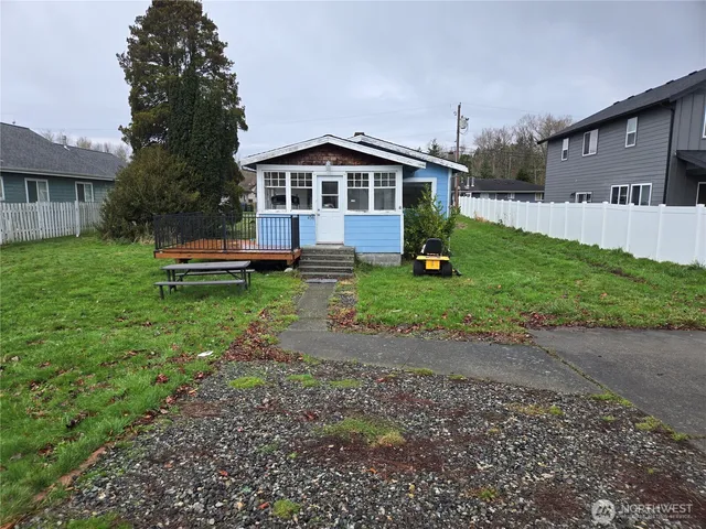 a front view of a house with a yard table and chairs