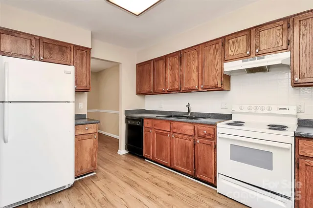 a kitchen with stainless steel appliances granite countertop a refrigerator sink and cabinets