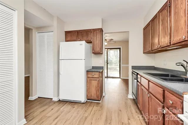 a kitchen with granite countertop wooden floors and stainless steel appliances