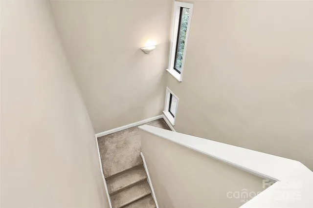 a view of staircase with wooden floor