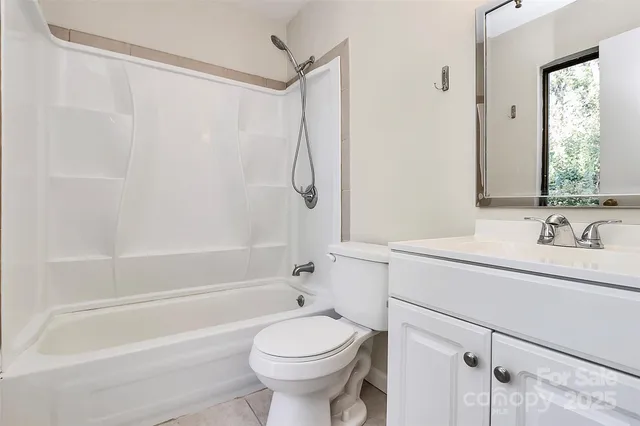 a bathroom with a shower curtain and a window