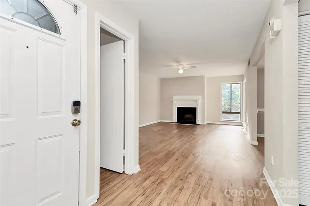 a view of a livingroom with wooden floor and fireplace