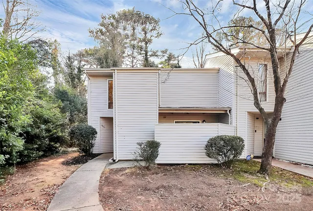 a view of a house with large trees
