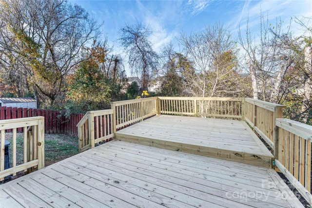 a view of deck with wooden floor and trees