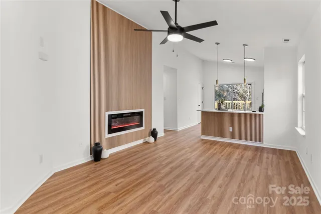 a view of an empty room with a fireplace and a window