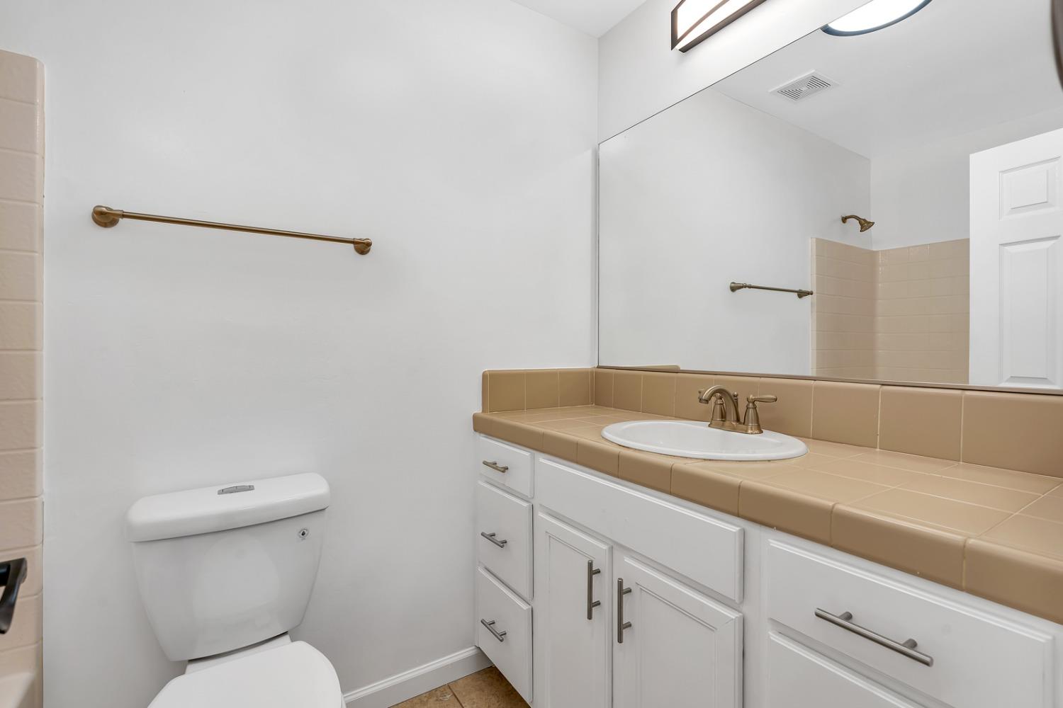 13612 Dromore Court Bakersfield, CA 93314 - Photo 16 of 35 a bathroom with a toilet sink and mirror