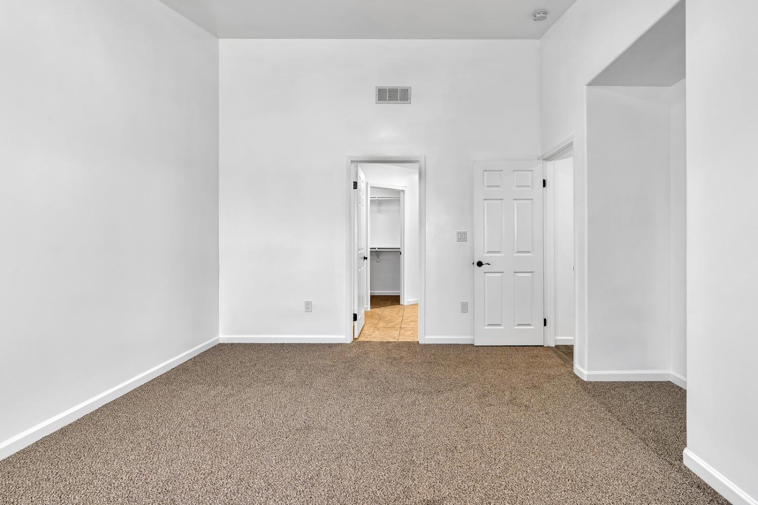 13612 Dromore Court Bakersfield, CA 93314 - Photo 20 of 35 an empty room with wooden door and windows