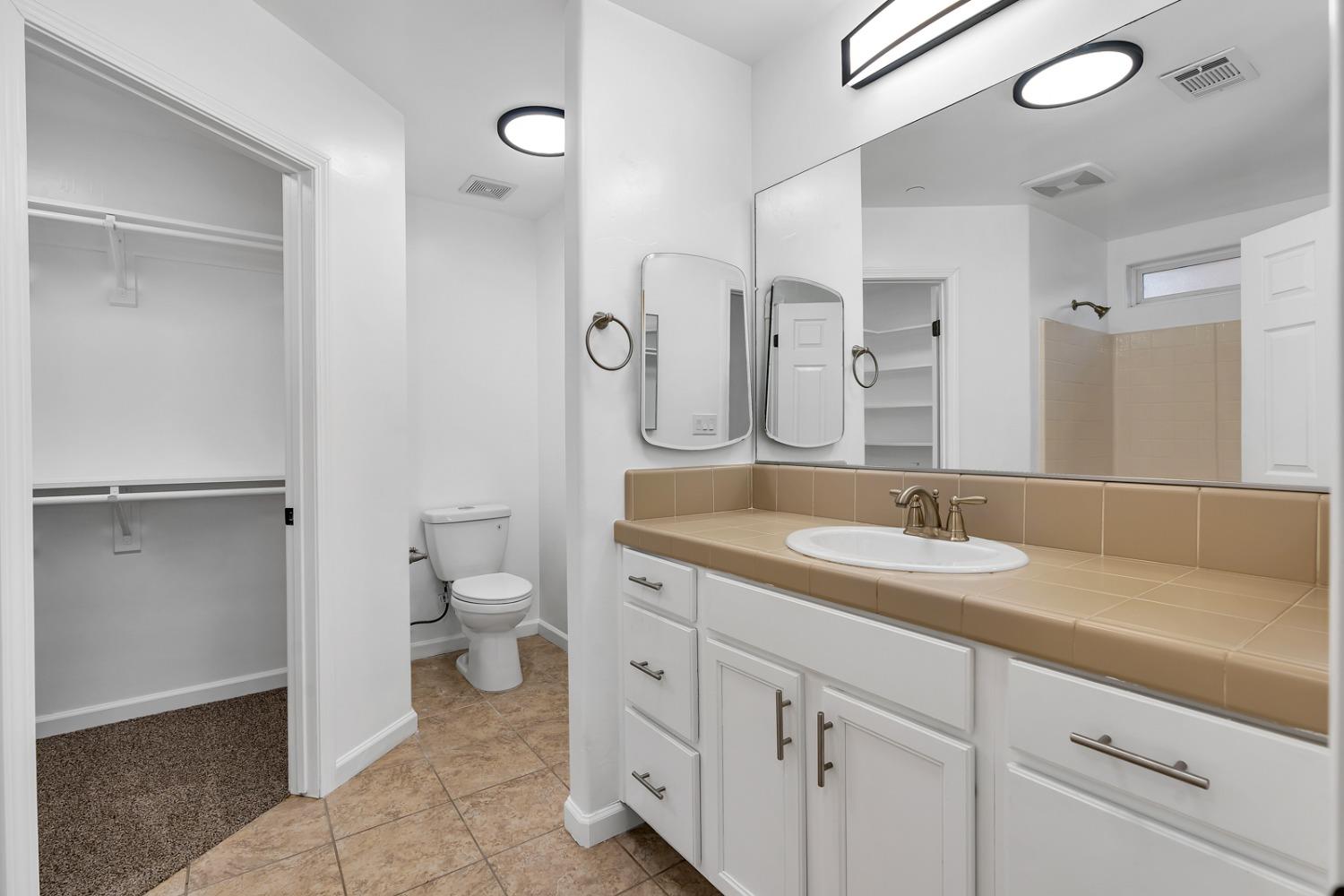 13612 Dromore Court Bakersfield, CA 93314 - Photo 21 of 35 a spacious bathroom with a granite countertop sink toilet and shower