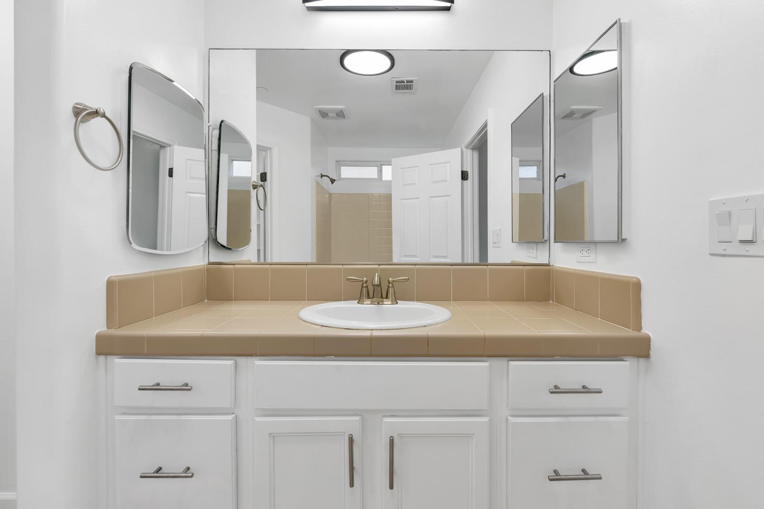 13612 Dromore Court Bakersfield, CA 93314 - Photo 22 of 35 a bathroom with a sink and a mirror