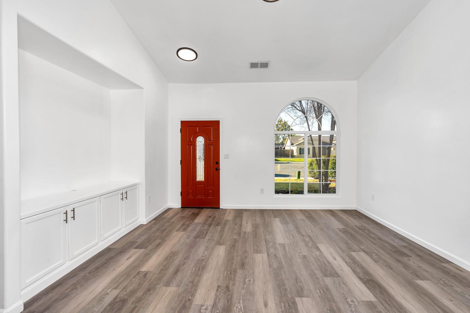 13612 Dromore Court Bakersfield, CA 93314 - Photo 8 of 35 wooden floor in an empty room with a window