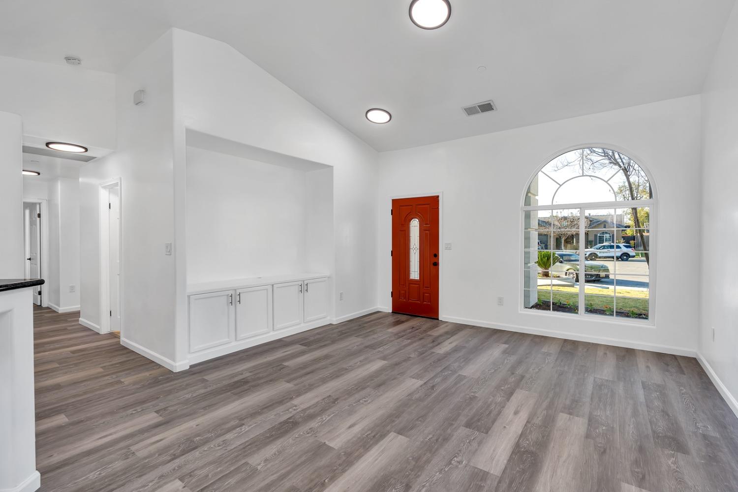 13612 Dromore Court Bakersfield, CA 93314 - Photo 9 of 35 a view of an empty room with wooden floor and a window