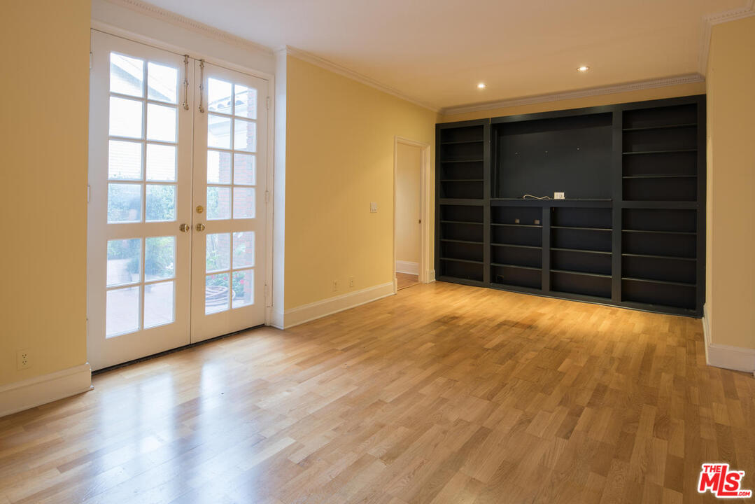 2237 Canyonback Road Los Angeles, CA 90049 - Photo 14 of 34 a view of an empty room with wooden floor and a window