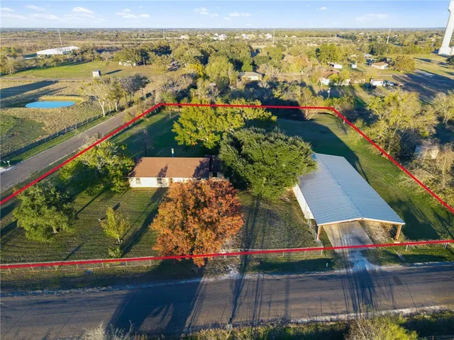 an aerial view of residential houses with outdoor space