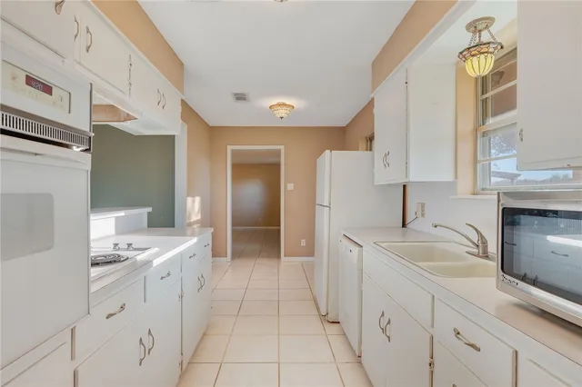 a spacious bathroom with a granite countertop sink and a mirror