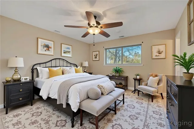 a bedroom with a bed and ceiling fan