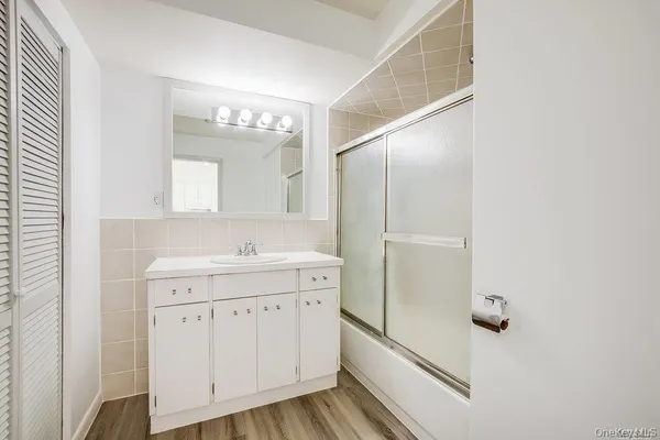 a bathroom with a sink a mirror and a shower