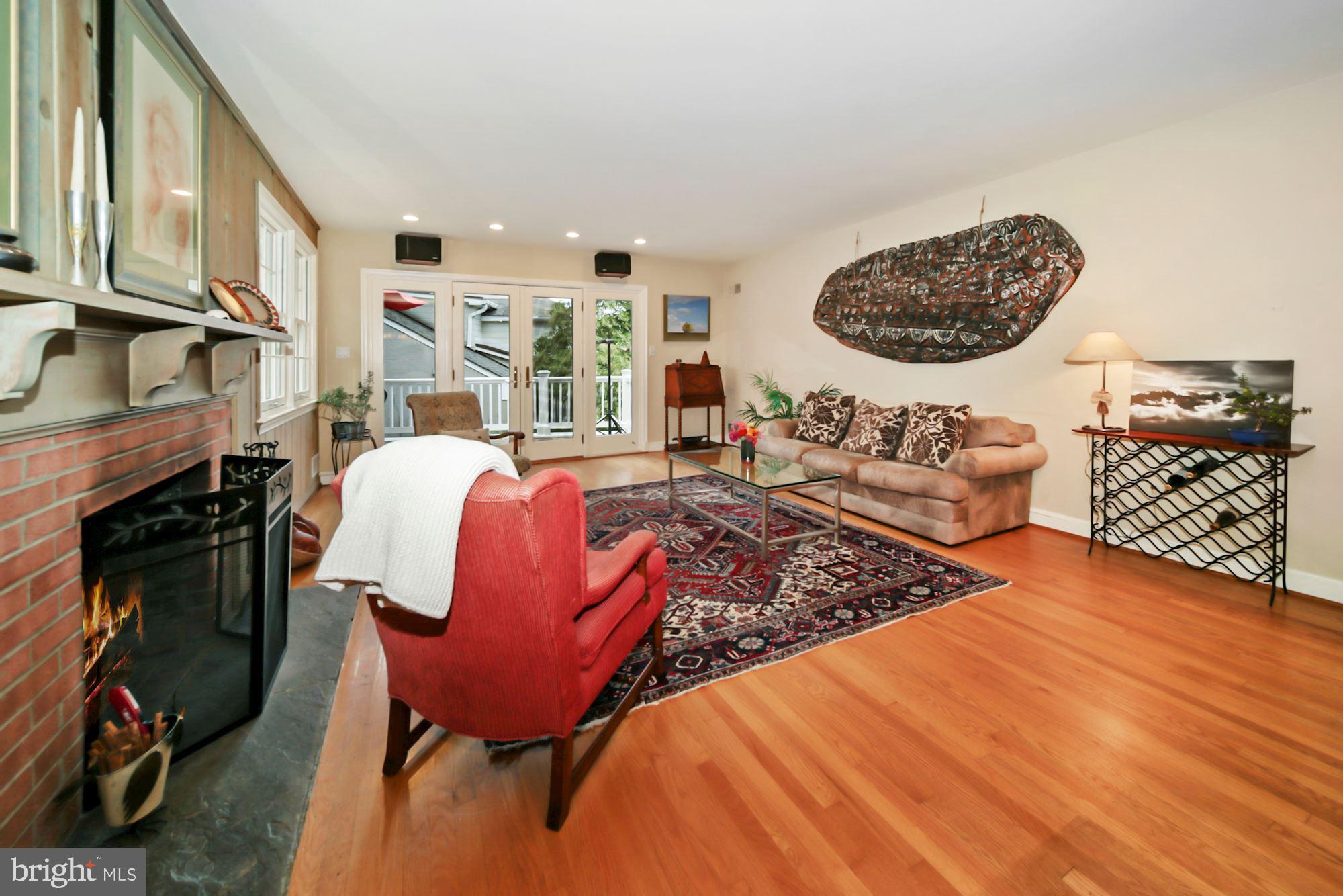 6002 Winnebago Road Bethesda, MD 20816 - Photo 5 of 54 Wood-burning fireplace, doors to deck