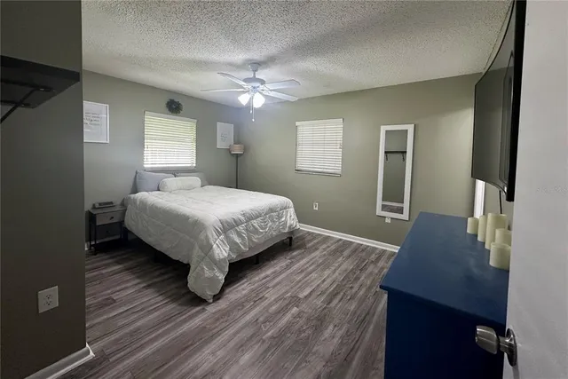 a bedroom with a bed lamp and a window