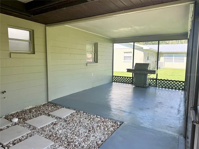 a view of a bedroom with wooden floor and a rug