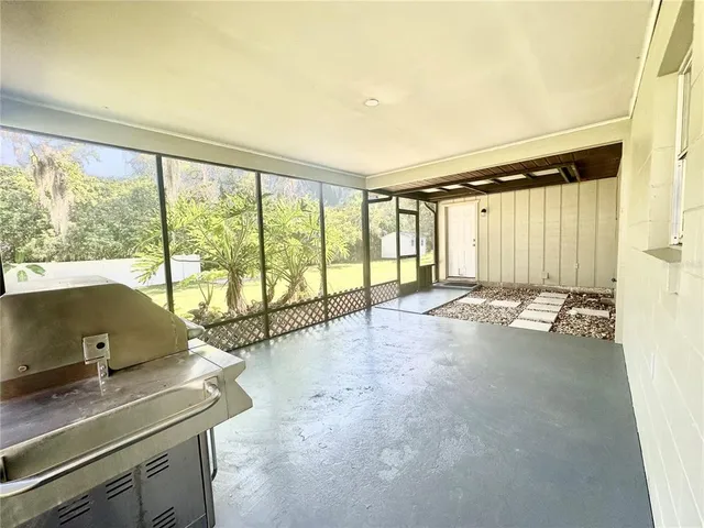 a view of a room with gym equipment and a large window