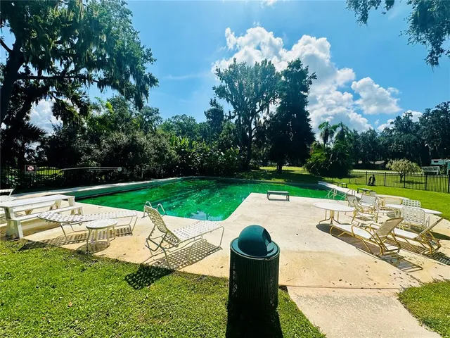 a view of a table and chairs in backyard of the house
