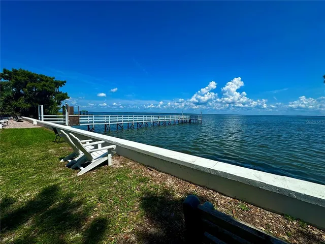 a view of a lake with a wooden deck