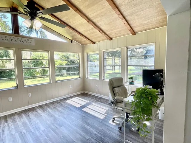 a workspace with wooden floor and a window