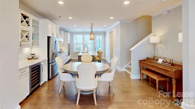a dining room with furniture and wooden floor