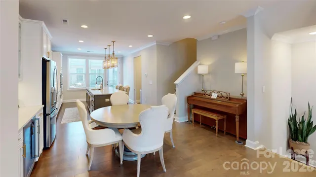 a dining room with furniture and a potted plant