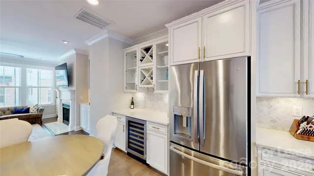 a kitchen with stainless steel appliances a refrigerator and wooden floor