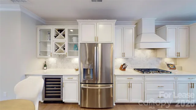 a kitchen with refrigerator and cabinets