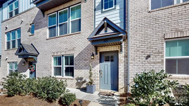 a view of a brick house with plants
