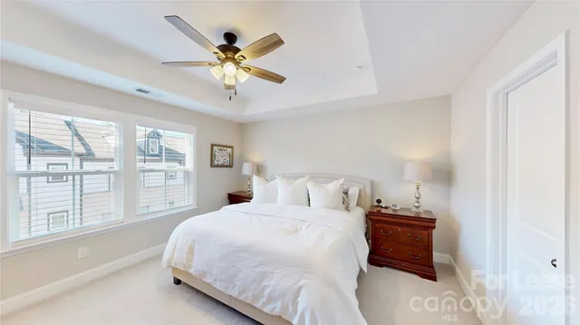 a bedroom with a large bed and a large window