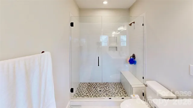 a bathroom with a shower and a sink